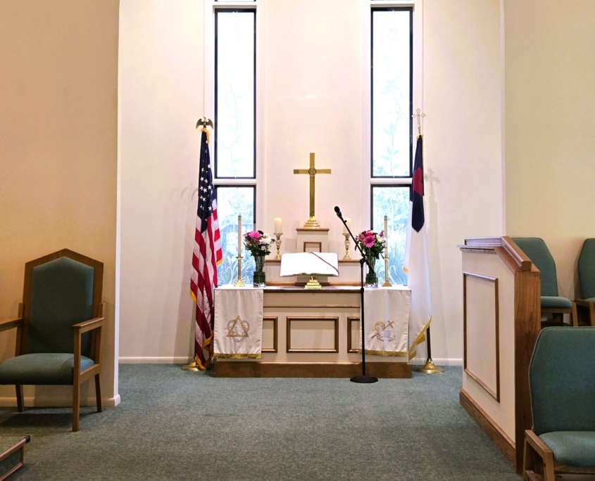 Chapel Alter with cross, flags and flowers