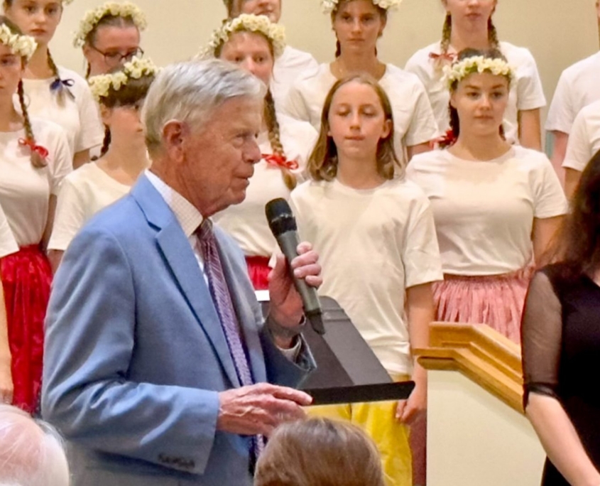 MC introducing all girls choir in chapel