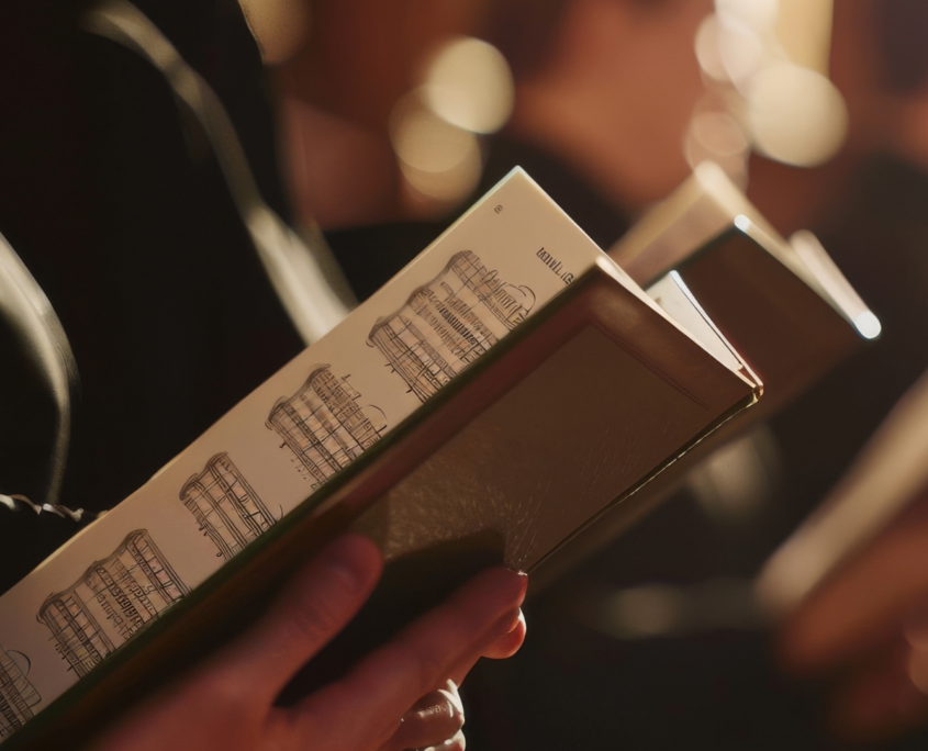 Row of singers with close up of sheet music