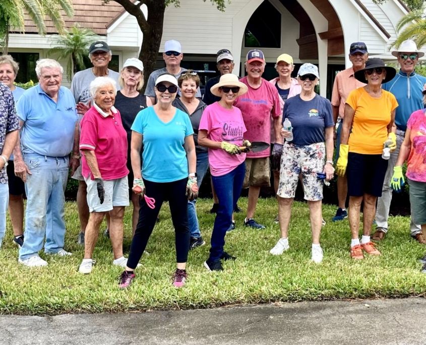 Volunteers under tree canopy after gardening at Chapel