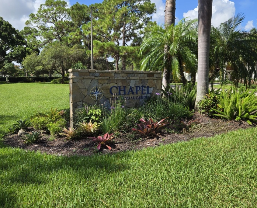 Chapel street sign surrounded by garden