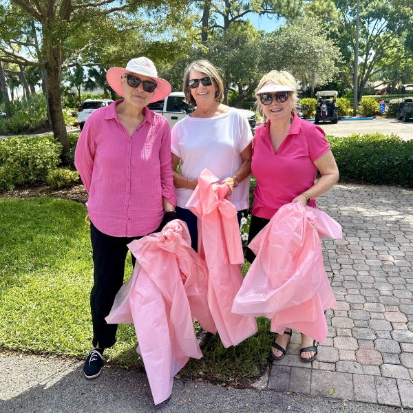 Three ladies with pink tulle to decorate the chapel