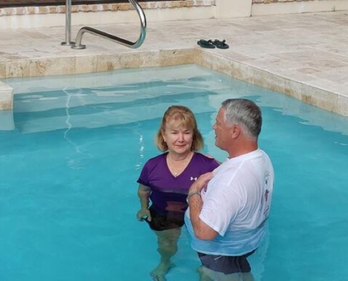 Pastor Carr rebaptizing MS member in her pool