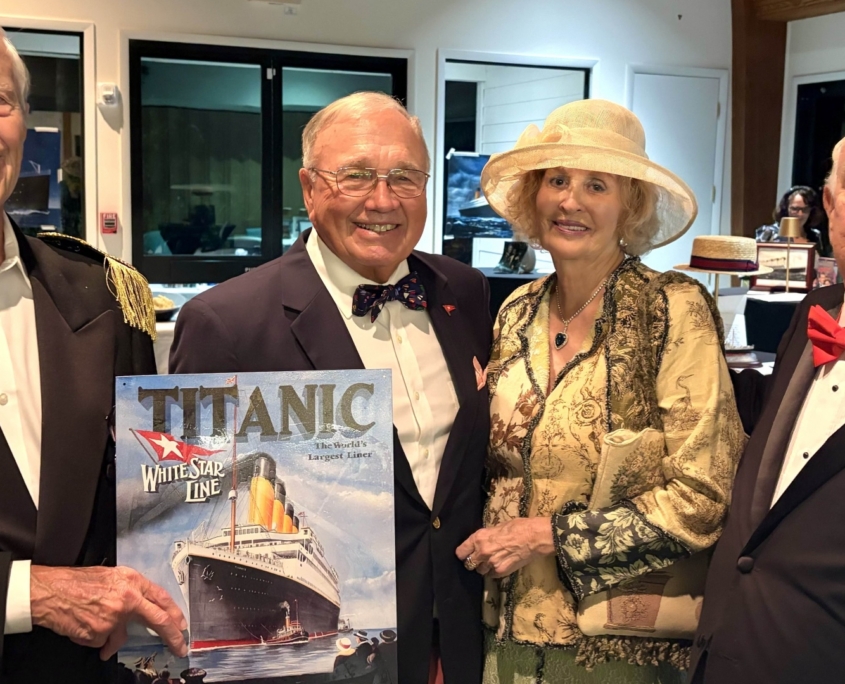 Man holding Titanic album cover with men in tuxedos and woman in 1920s dress and hat