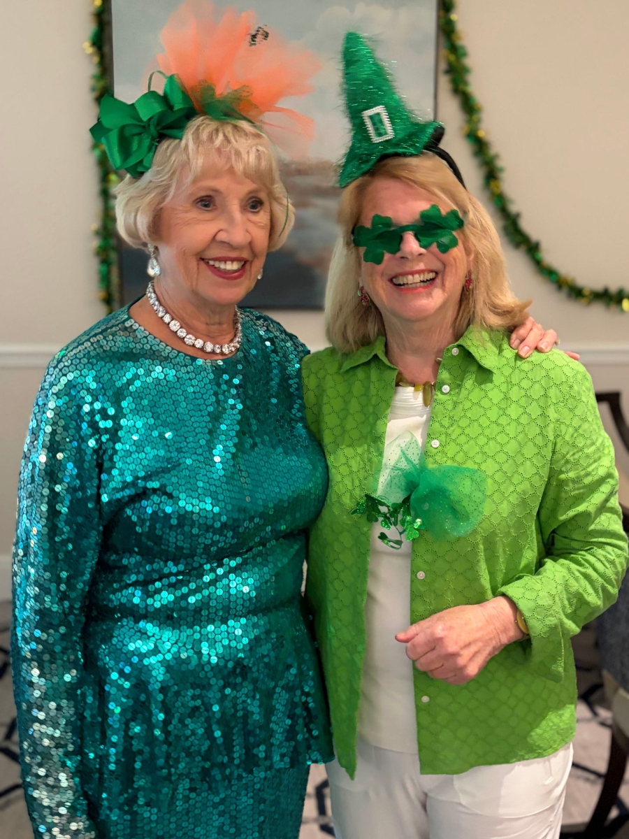 Two women dressed in green and wearing St. Patrick's Day hats