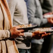 Close up of people holding trays of bread for communion