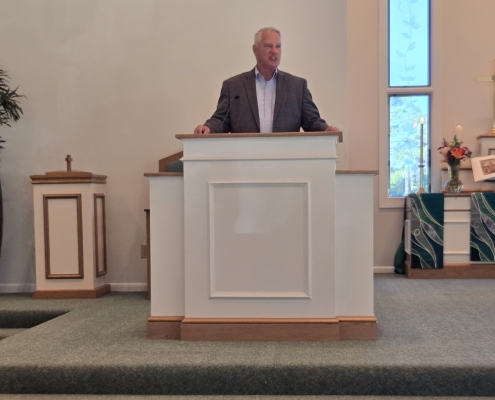 Pastor Carr stands behind new pulpit in Chapel sanctuary